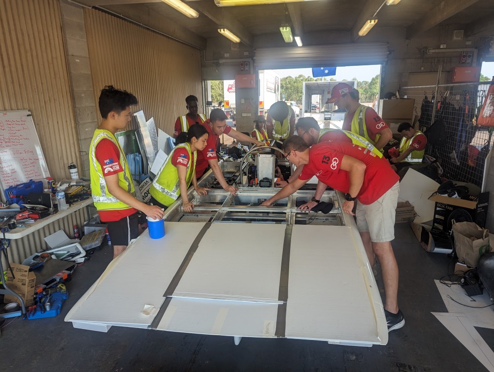 Image of me working on solar car in pit lane.