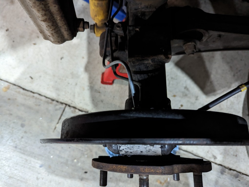 The replaced brake line on the rear axle.