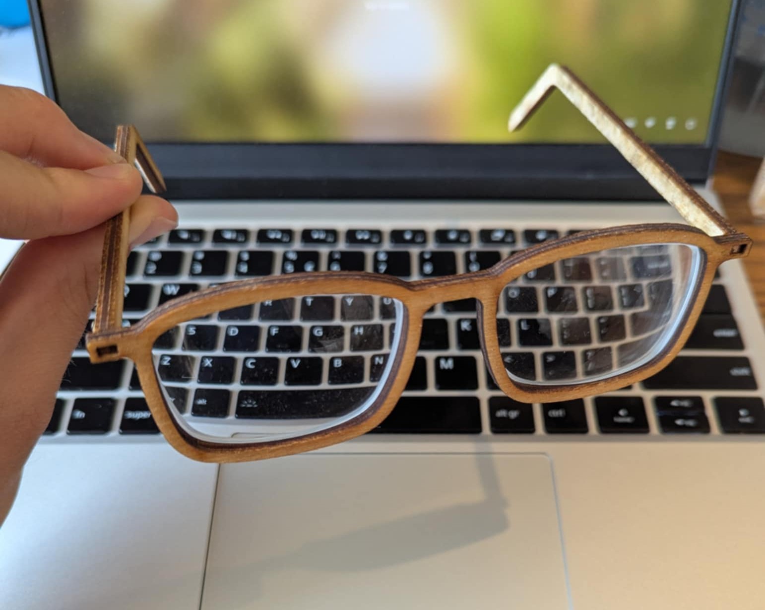 Holding the glasses by the arm to check rigidity.